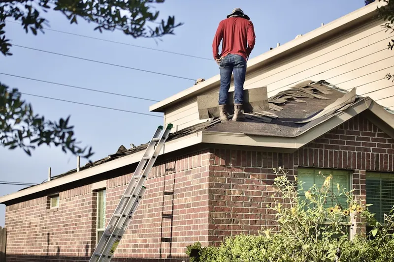 Professional roofer working on a residential roof in Ballpark